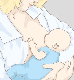 Mutter stillt ihr Kind im Wiegegriff.
